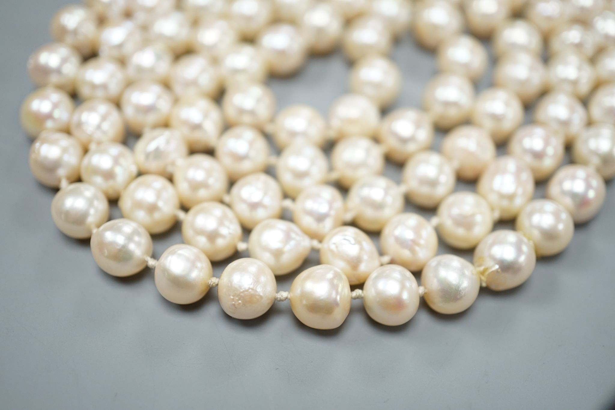 A long single strand baroque cultured pearl necklace, 128cm.